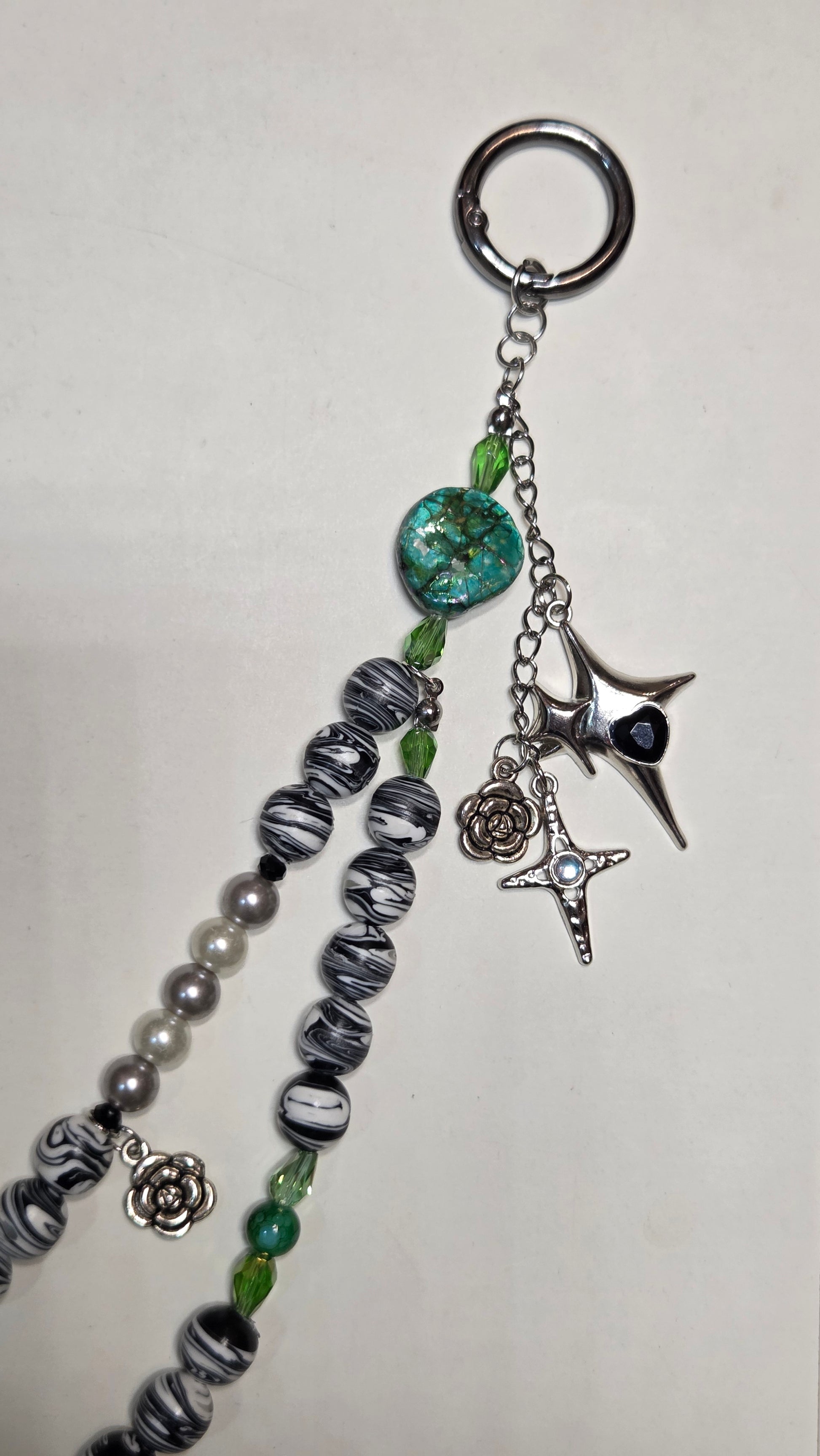 Keychain with beads and charms on a light gray background