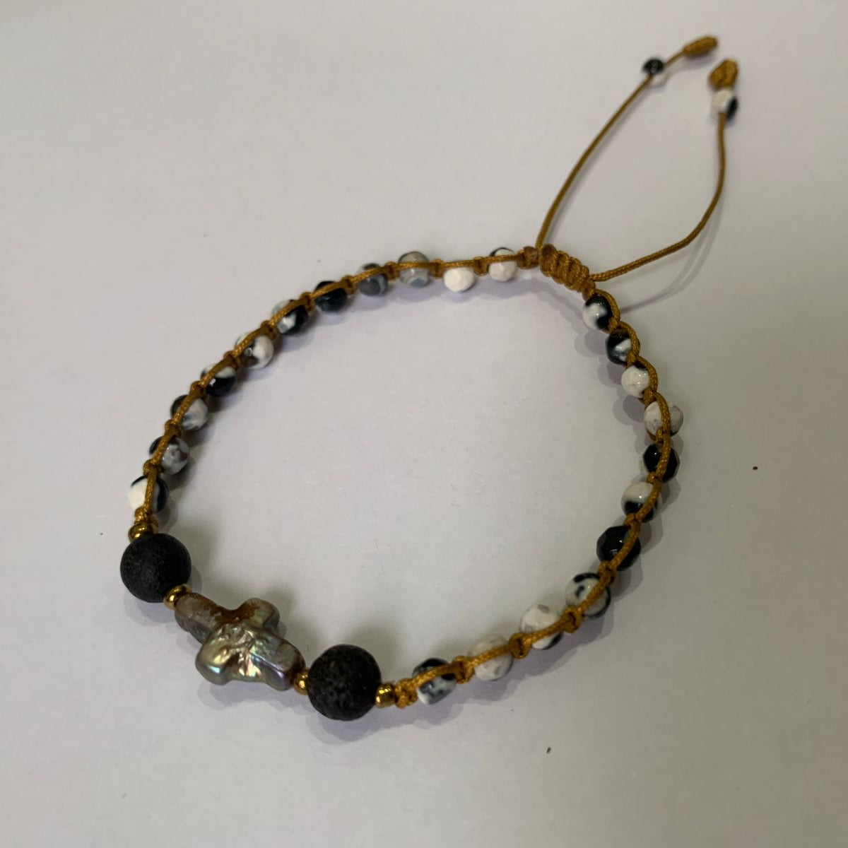 Beaded bracelet with snowflakes stone black, white, and baroque pearl Cross, and lava stone diffuser